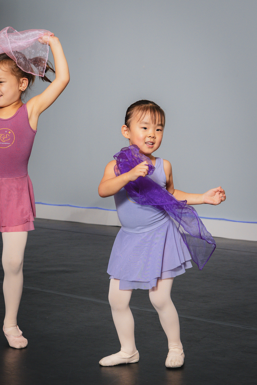 Two preschool dancers playing with scarves in a REvBabies class at Revolution Dance Academy