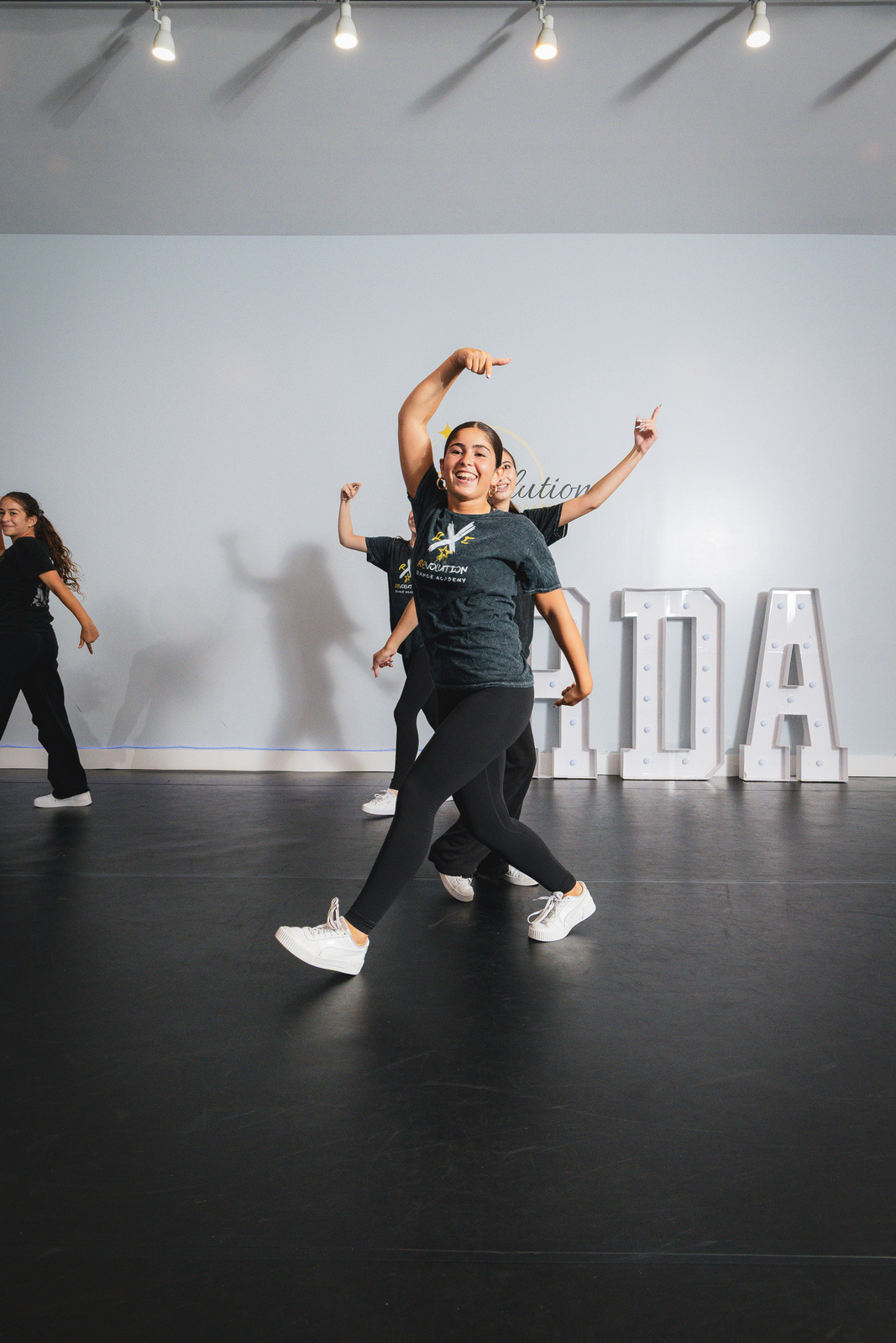 A young hip hop dancer posing in front of the RDA marquee letters