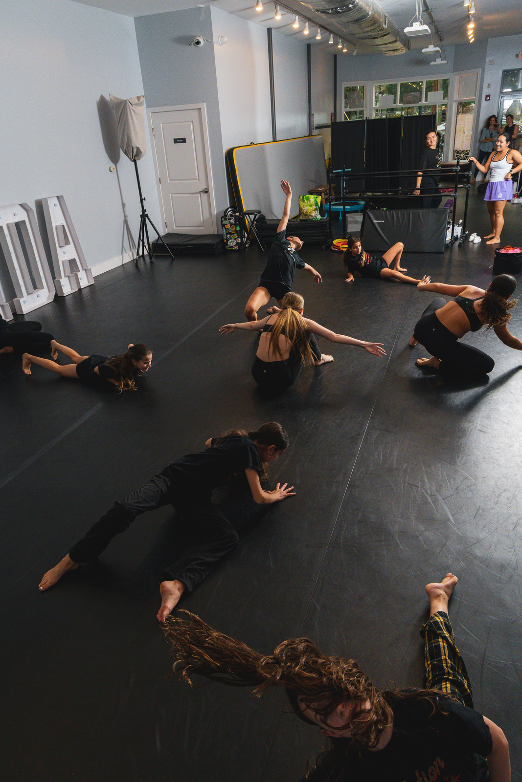 Contemporary dancers rehearsing floorwork at Revolution Dance Academy