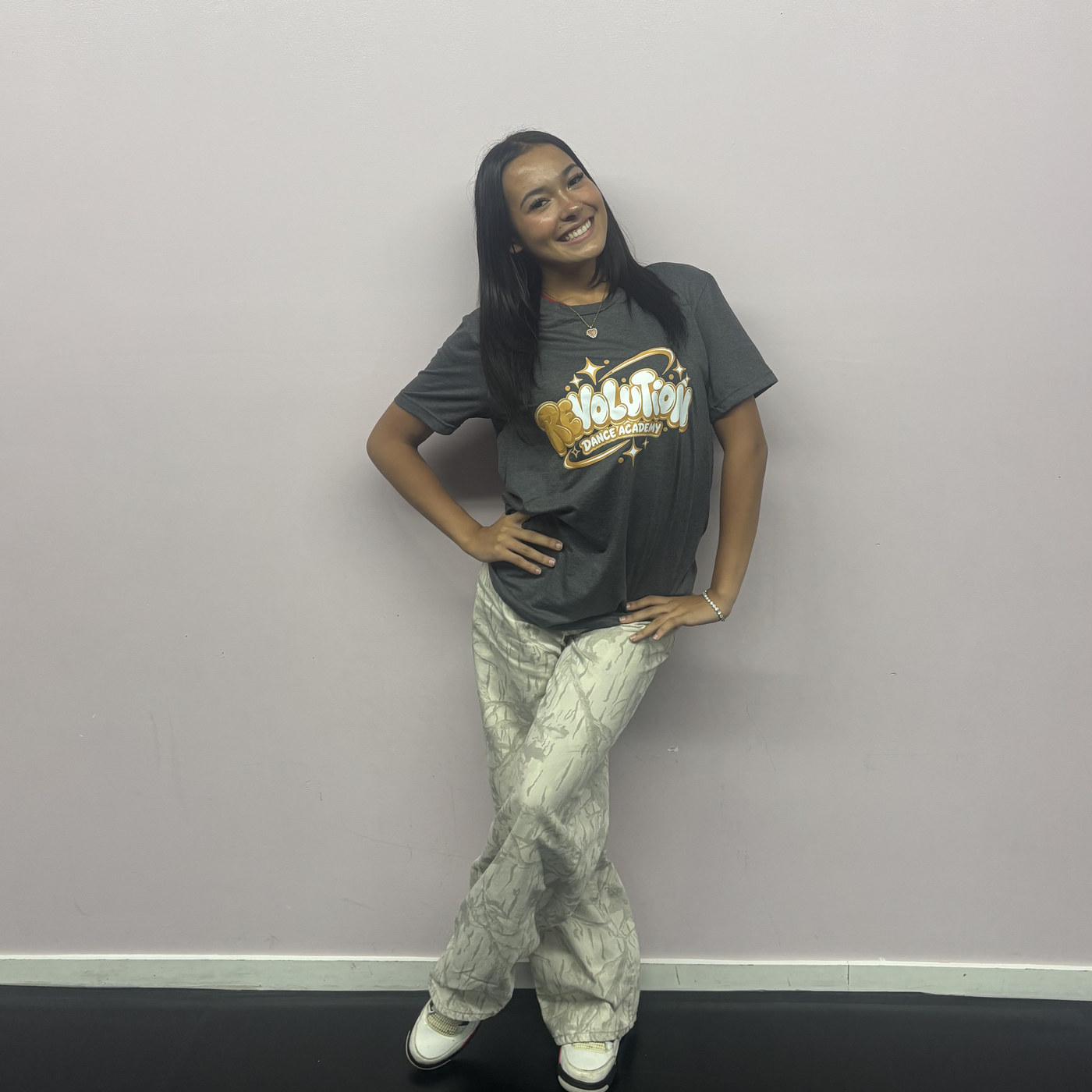Arianna Caride posing hand on hip in the Revolution Dance Academy studio