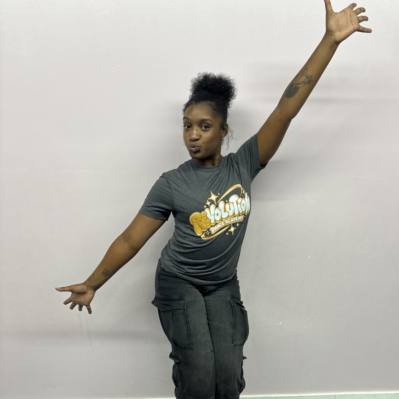 Sydney Sweeting with an arm raised in a playful pose at Revolution Dance Academy