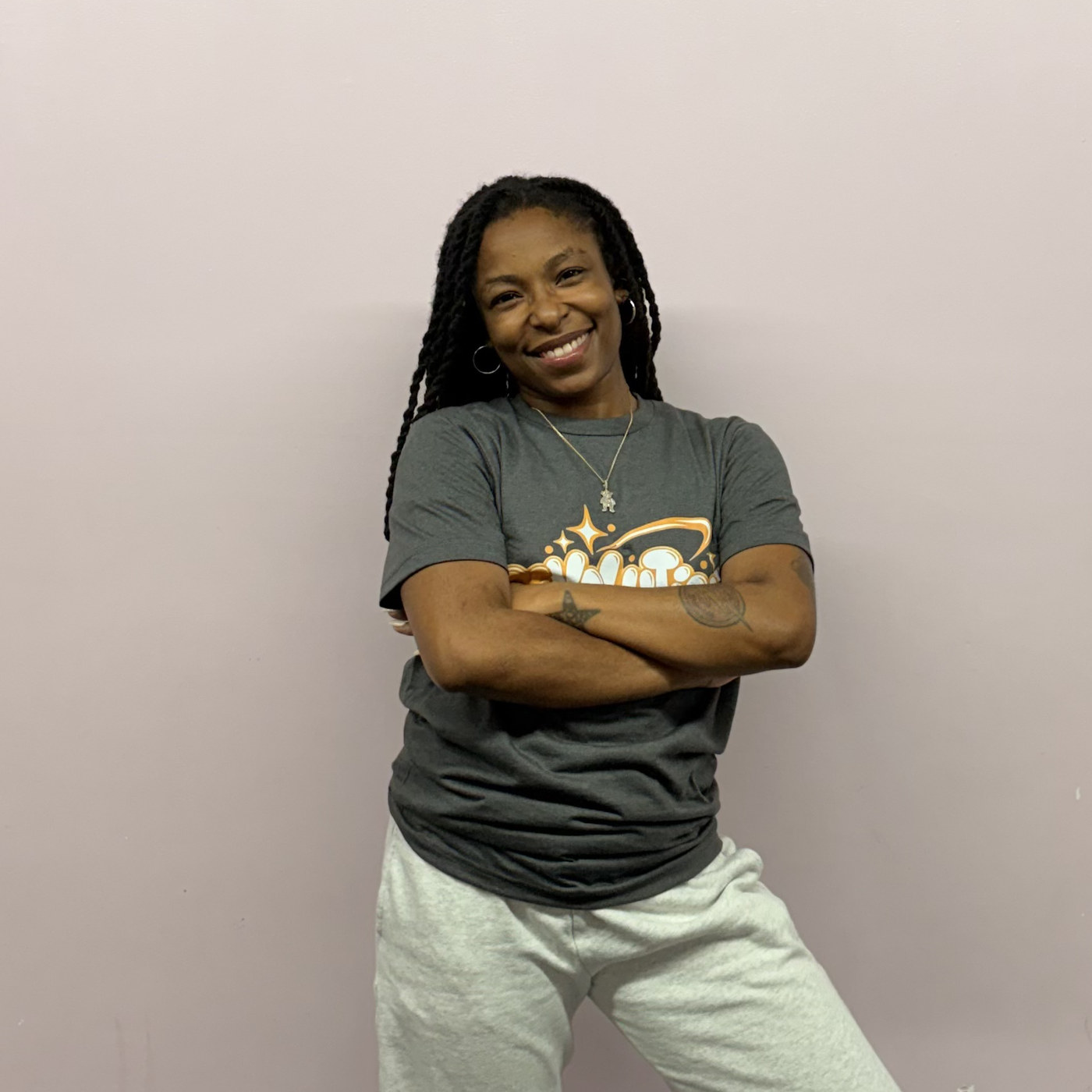 Crystal Samuel posing with arms crossed in the Revolution Dance Academy studio