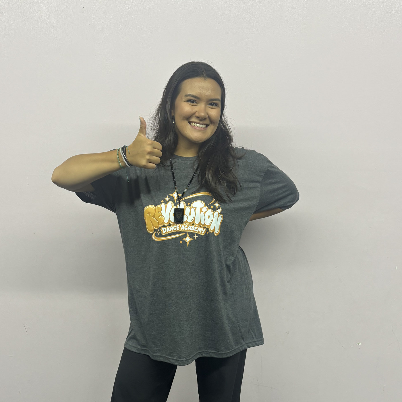 Emma Bednarski giving a thumbs up in the Revolution Dance Academy studio
