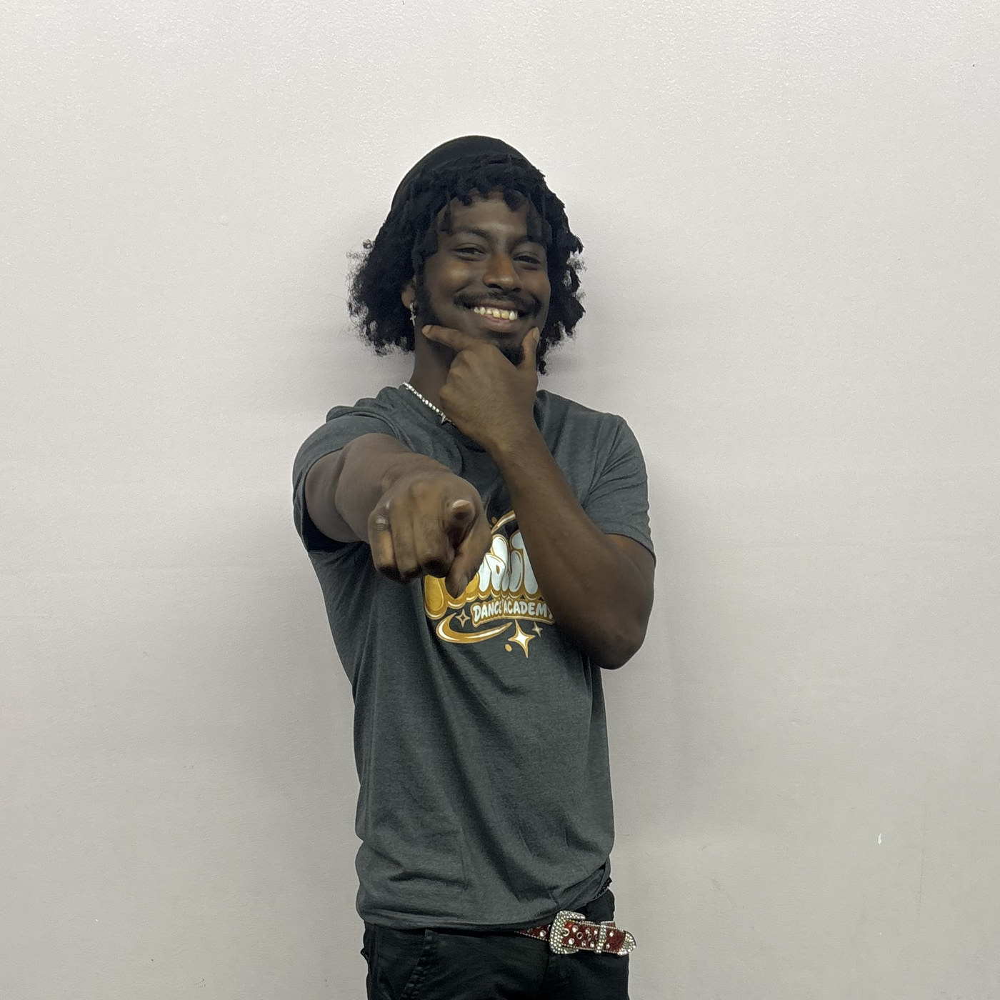 Shandon Pereira striking a hip hop pose in the Revolution Dance Academy studio