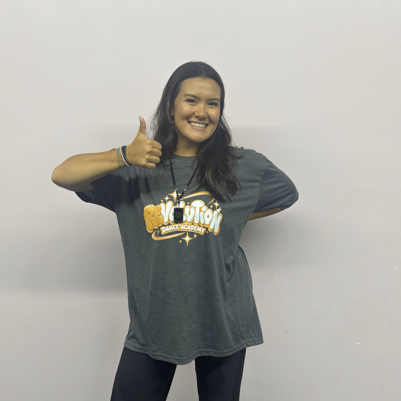 Emma Bednarski giving a thumbs up in the Revolution Dance Academy studio