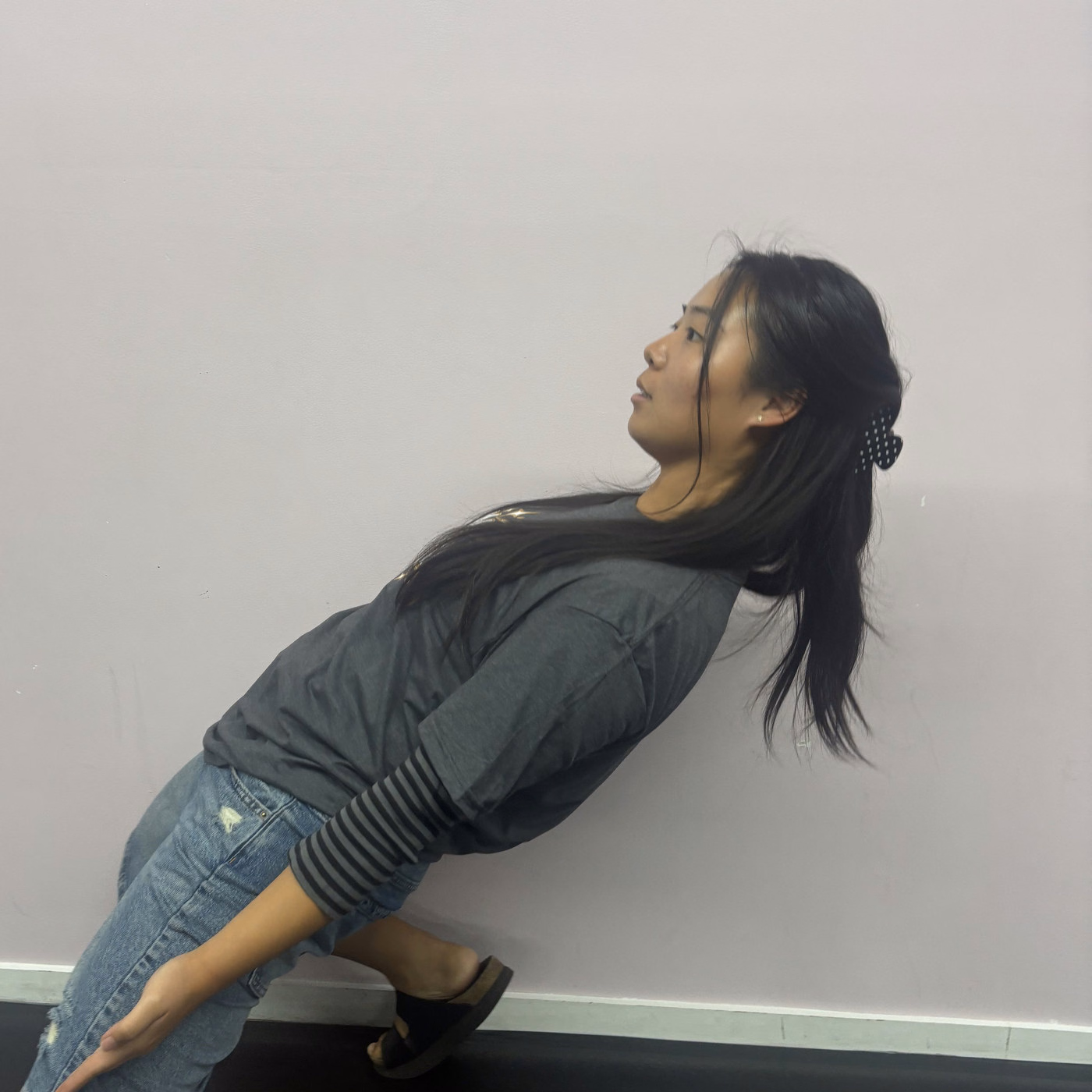 Abigail Yi striking a playful pose in the Revolution Dance Academy studio