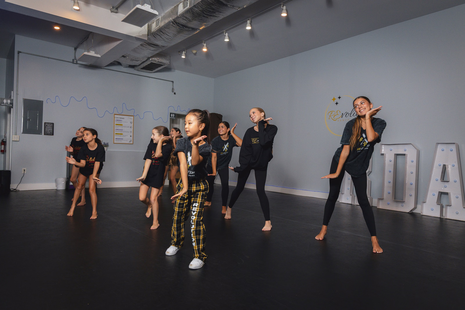 K-Pop students practicing formation choreography at Revolution Dance Academy in Tenafly, NJ