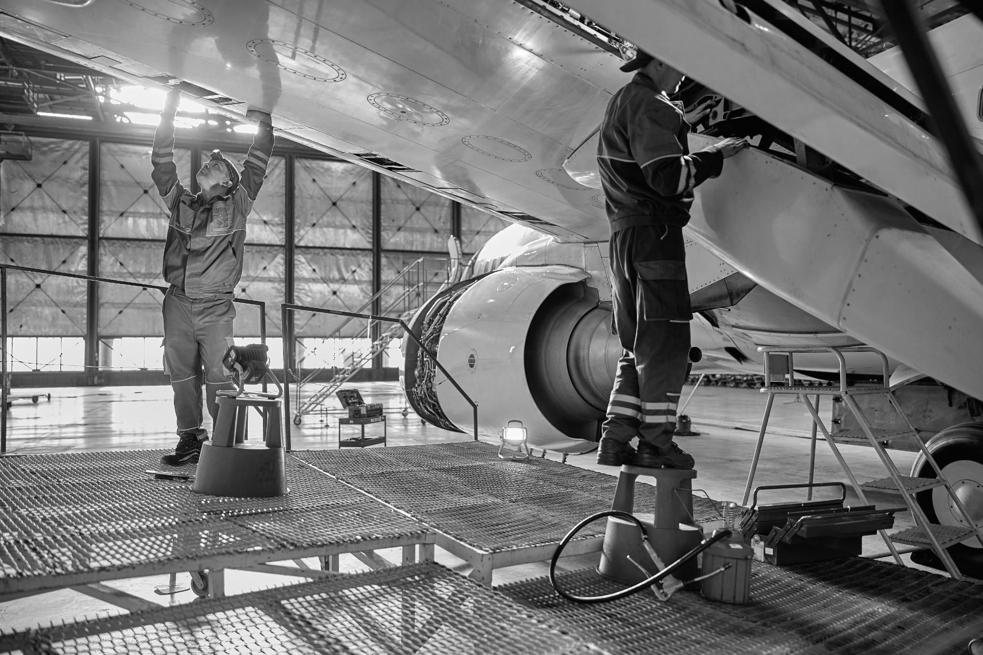 Line maintenance crew working an airframe in the hangar