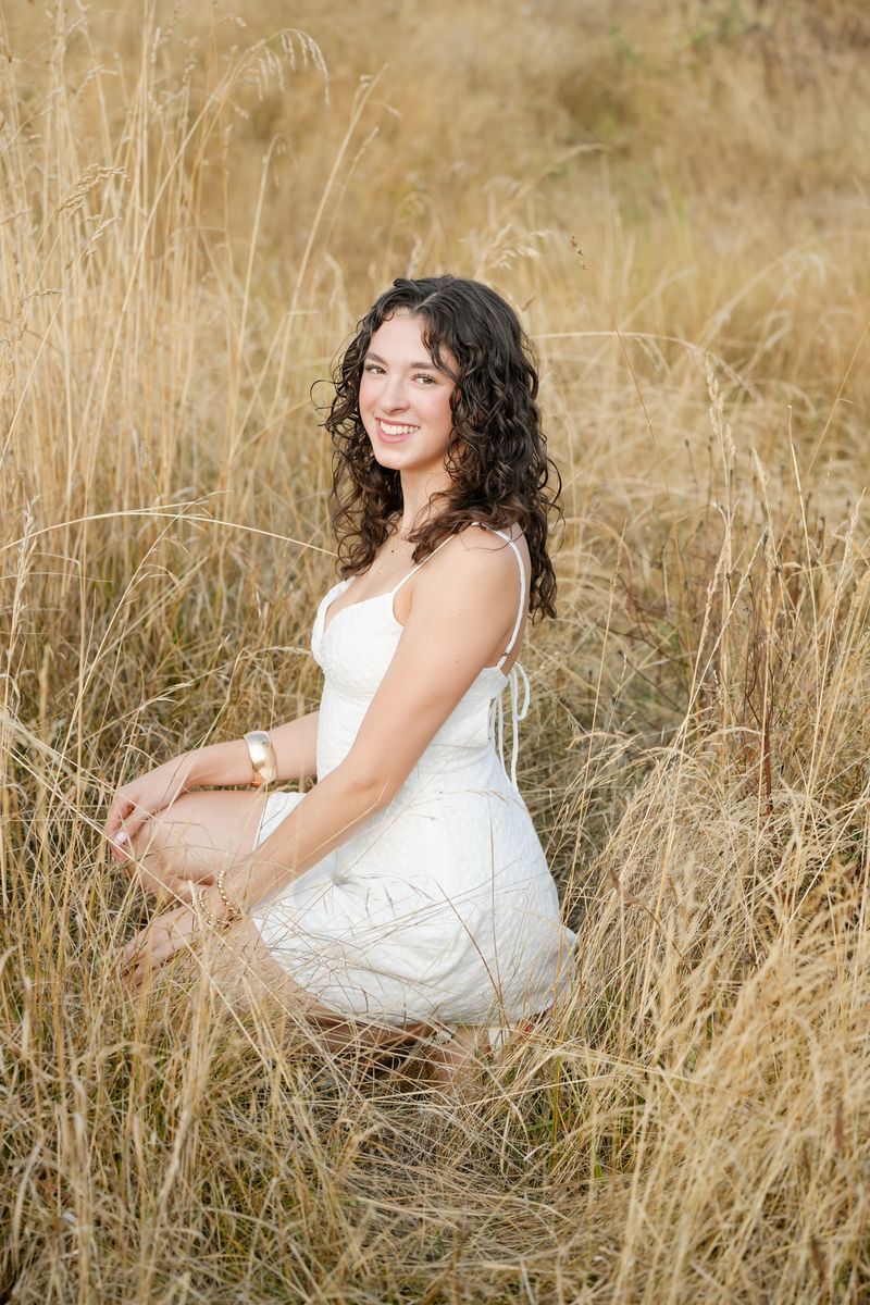 Julie posing for a portrait in the grass