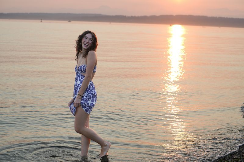 Julie smiling in a portrait at sunset