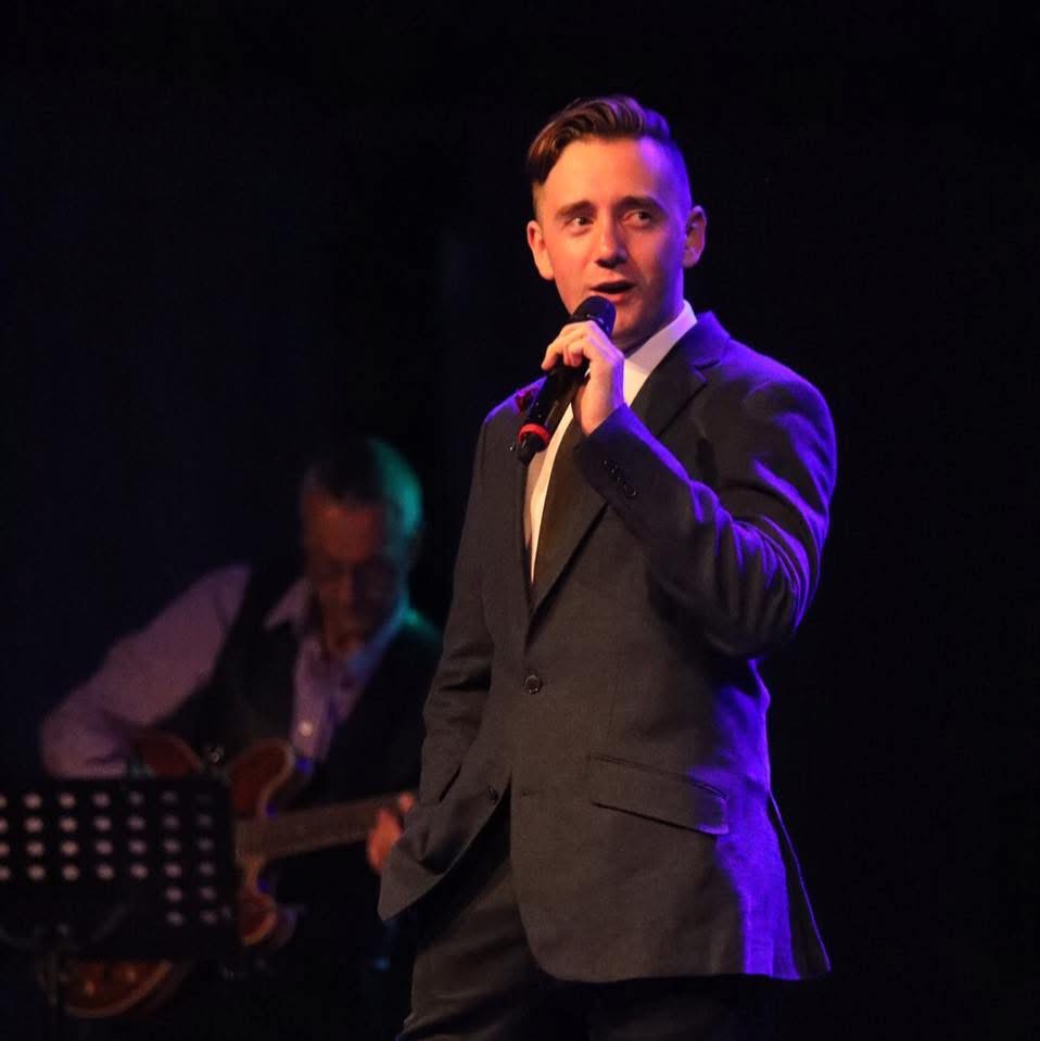 Ben Wilson performing with a microphone