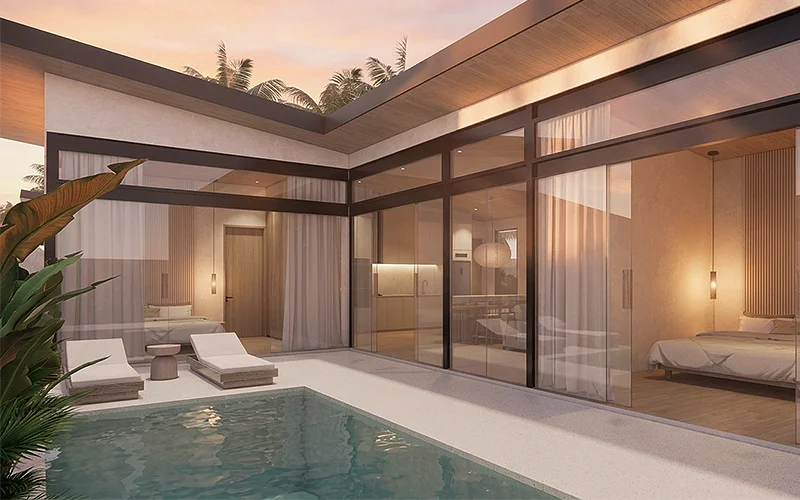 Villa exterior at dusk, the living room lit behind the glass and the pool in front