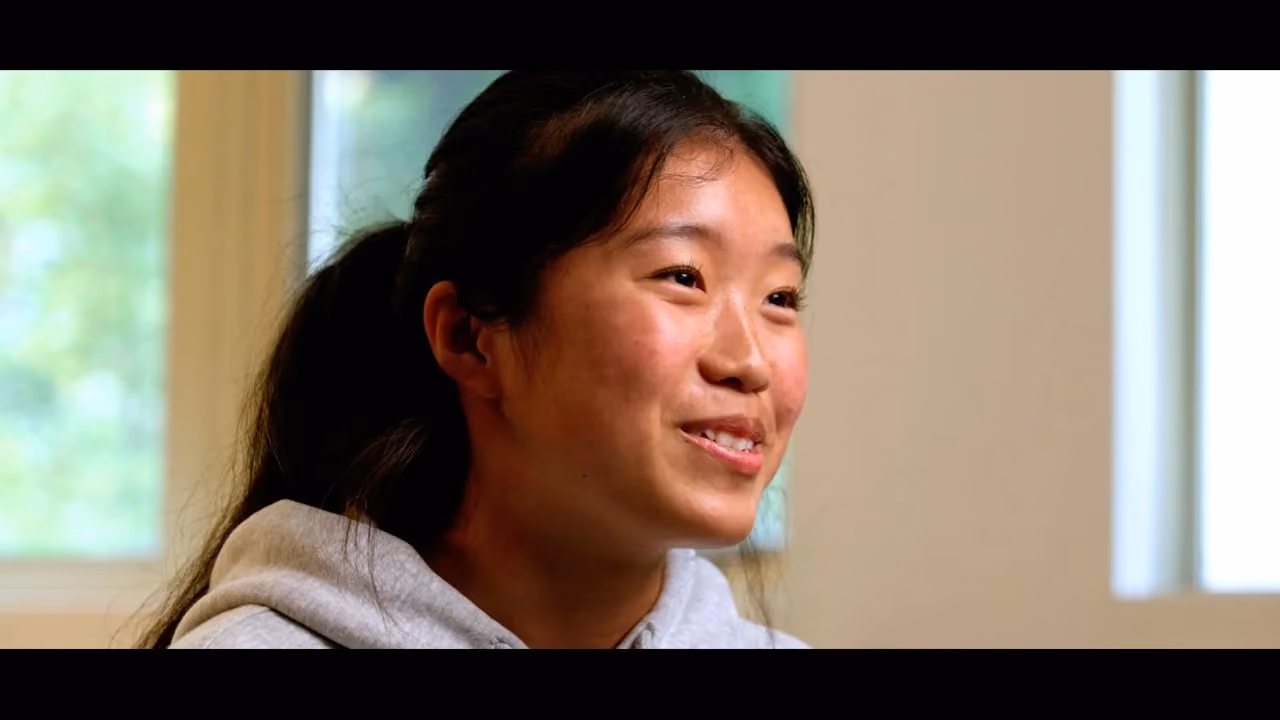 Danielle smiling indoors while sharing her baptism story.
