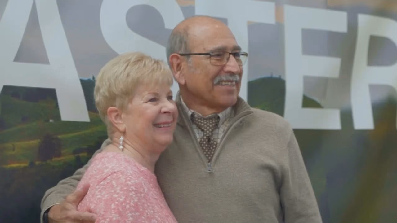 Al and Linda, an elderly couple, smiling together after their miracle story.