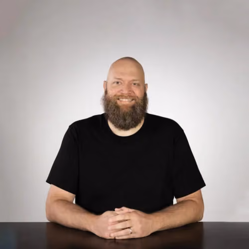 Eric Lynch, an Overseer at Northshore Church, smiling at a table.