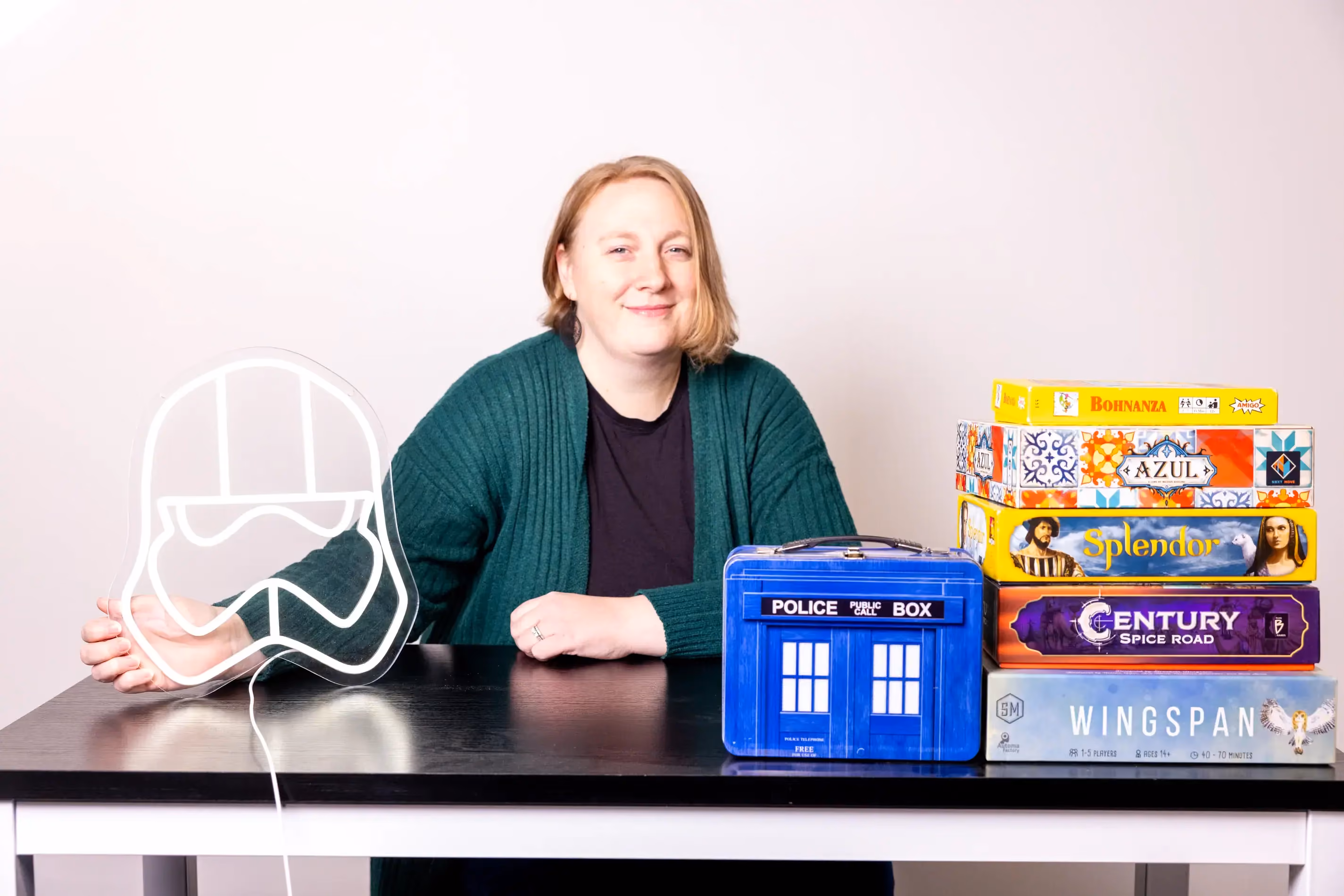 Tina Pierce posing with board games and a star in a candid staff photo.
