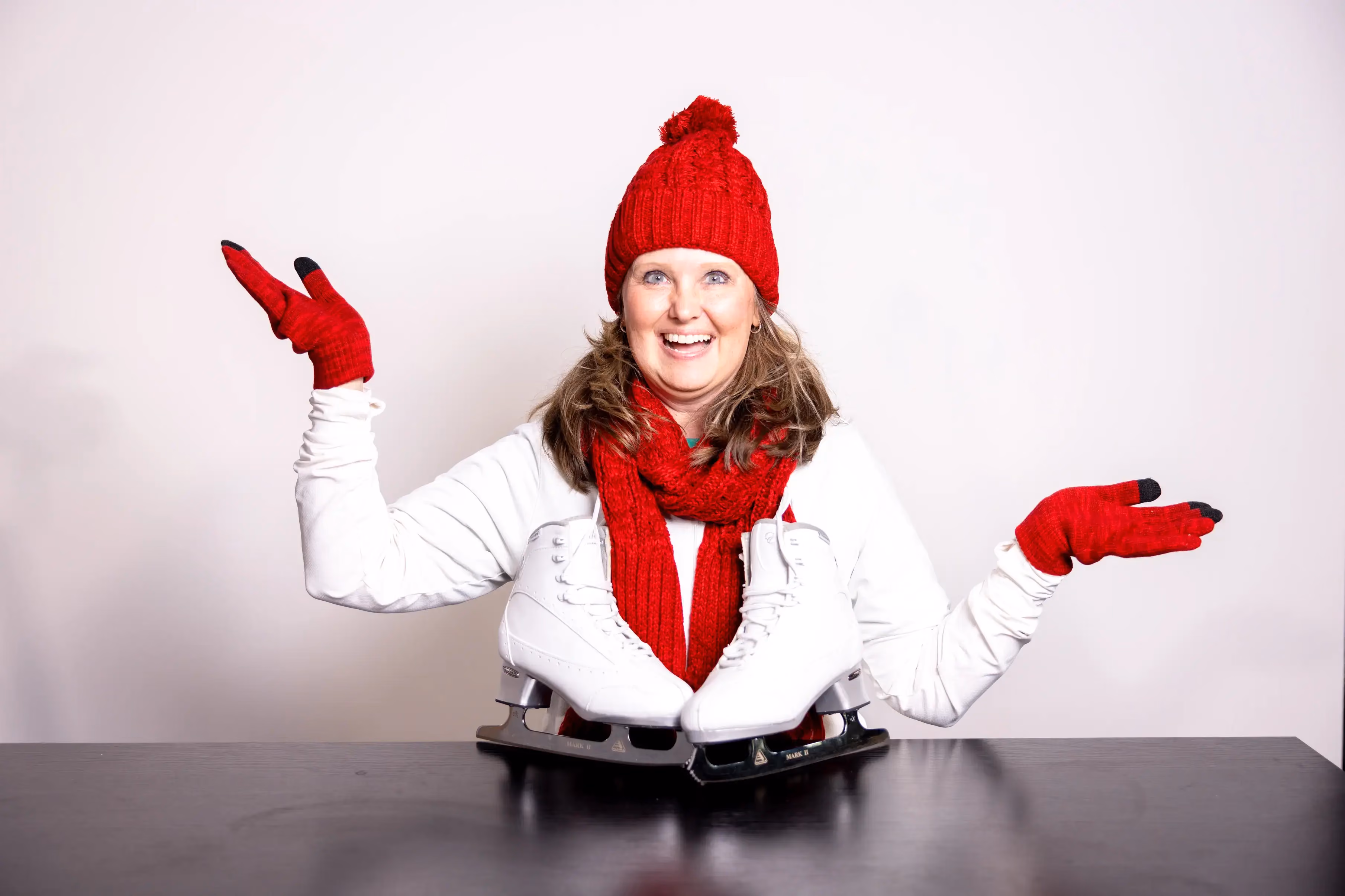 Stacie Salva wearing a red hat and ice skates in a candid staff photo.