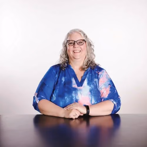Ginny Roos, NextGen Coordinator at Northshore Church, wearing glasses and tie-dye.