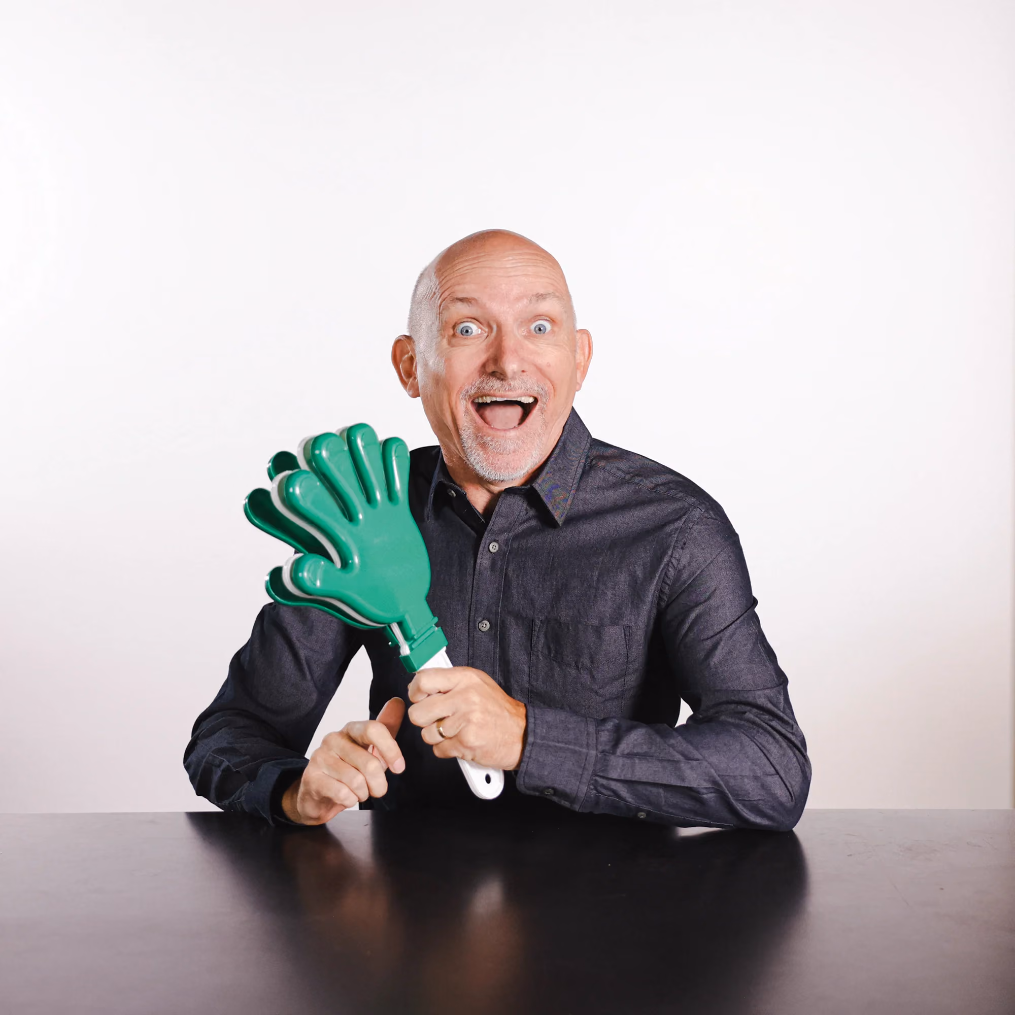 Gary Lindsay holding a green hand fan in a candid staff photo.