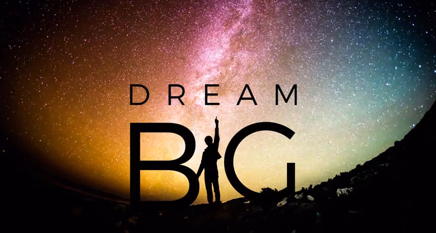 Silhouette of a person standing on a hill under a starry sky with the words Dream Big.