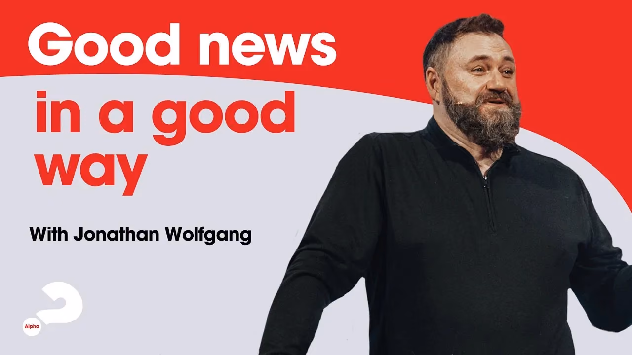 Man with beard in black shirt against red and white background with text Good news in a good way with Jonathan Wolfgang.