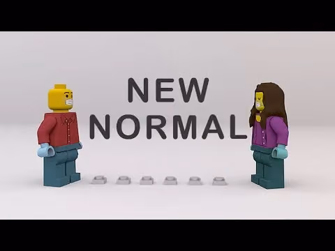 Two Lego minifigures stand apart with social distancing markers in front of text reading New Normal.