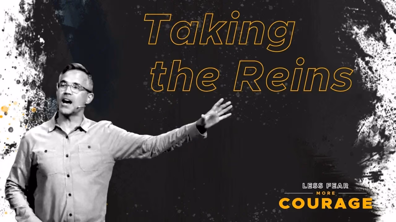 Man speaking with outstretched arm against dark background with text Taking the Reins and Less Fear More Courage.