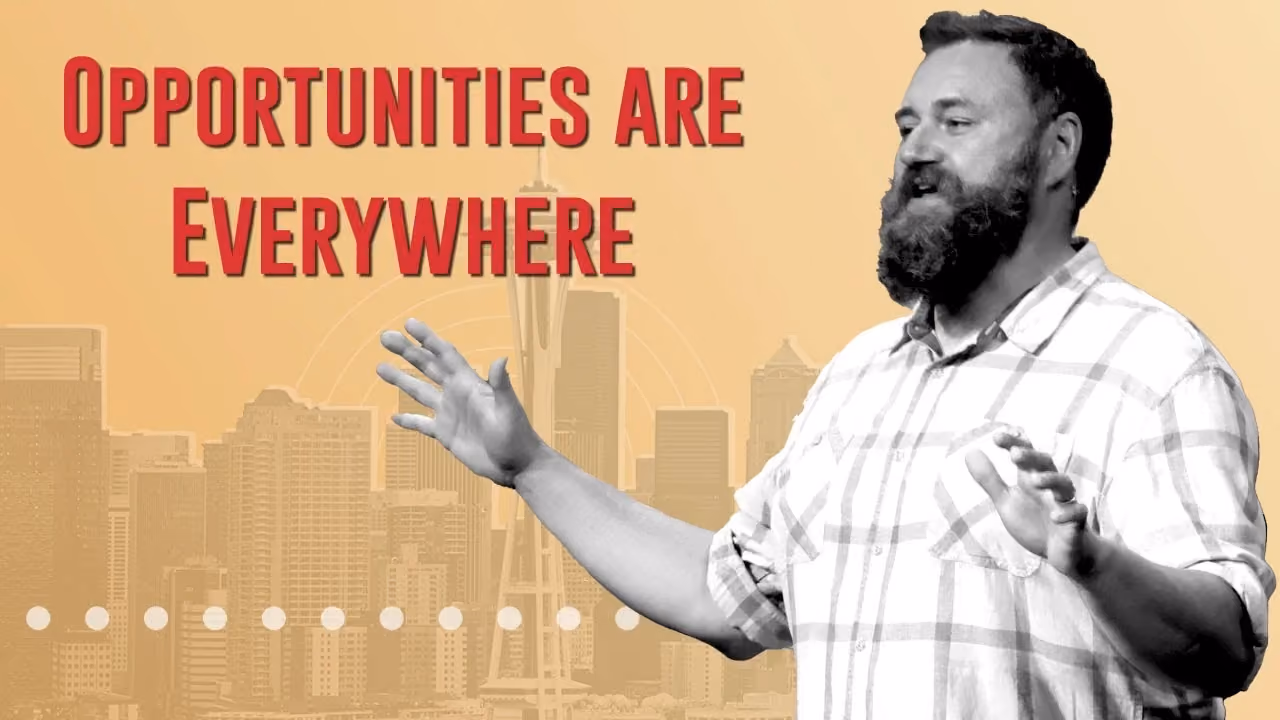 Man gesturing with city skyline background and text opportunities are everywhere.