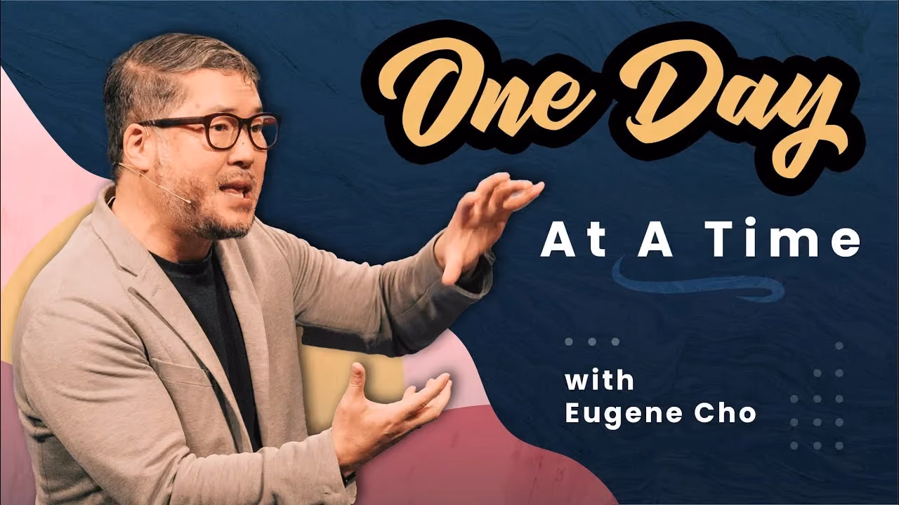 One Day At A Time with Eugene Cho, gesturing mid-sentence in glasses and a light blazer.