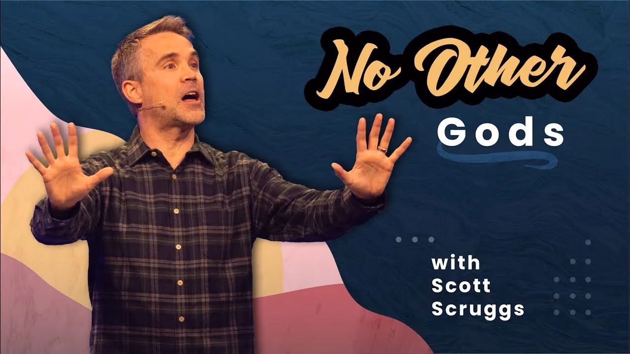 No Other Gods with Scott Scruggs, both palms raised while preaching on stage.