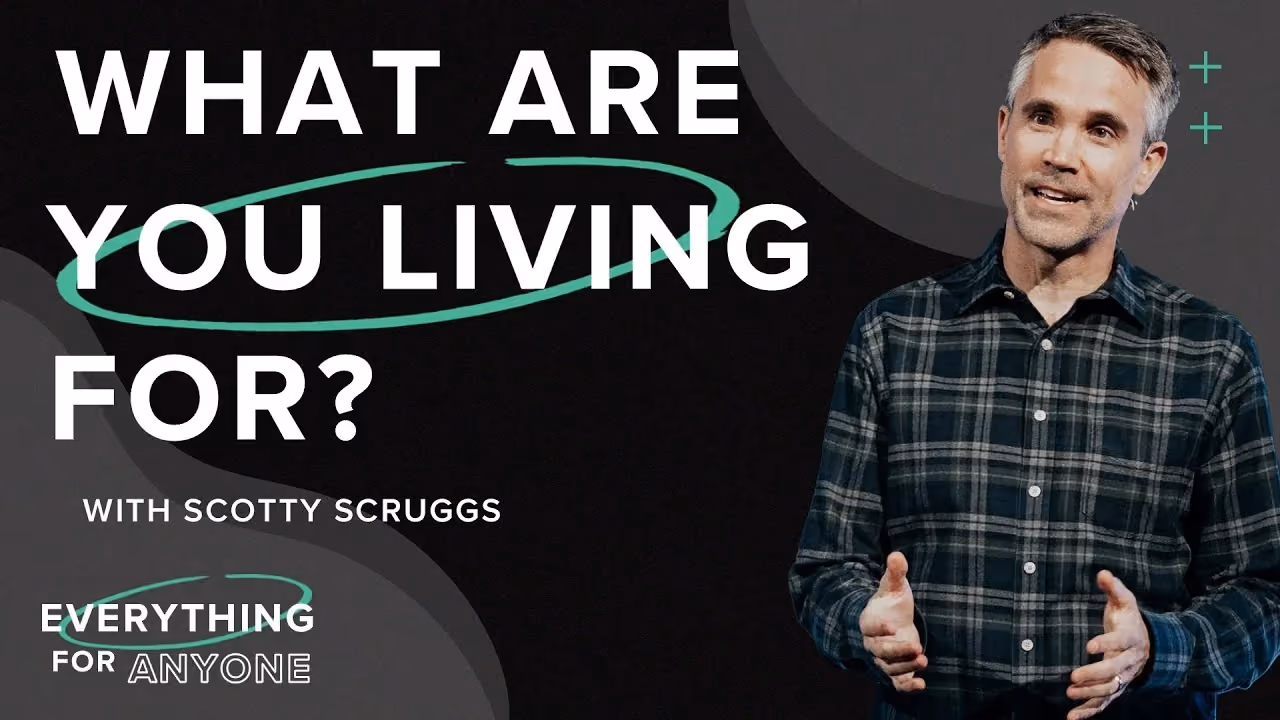 What Are You Living For? with Scotty Scruggs, hands open mid-sentence in a plaid shirt.