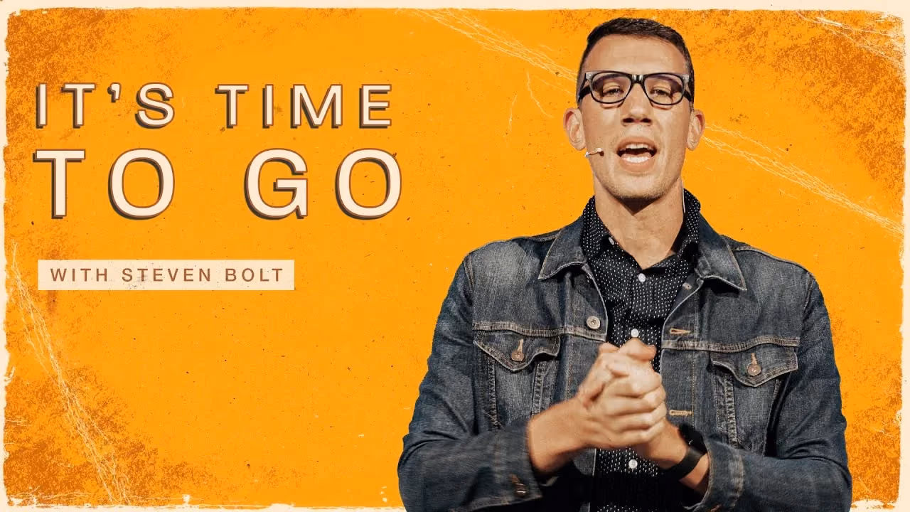 It's Time To Go with Steven Bolt, hands clasped in a denim jacket on an orange backdrop.