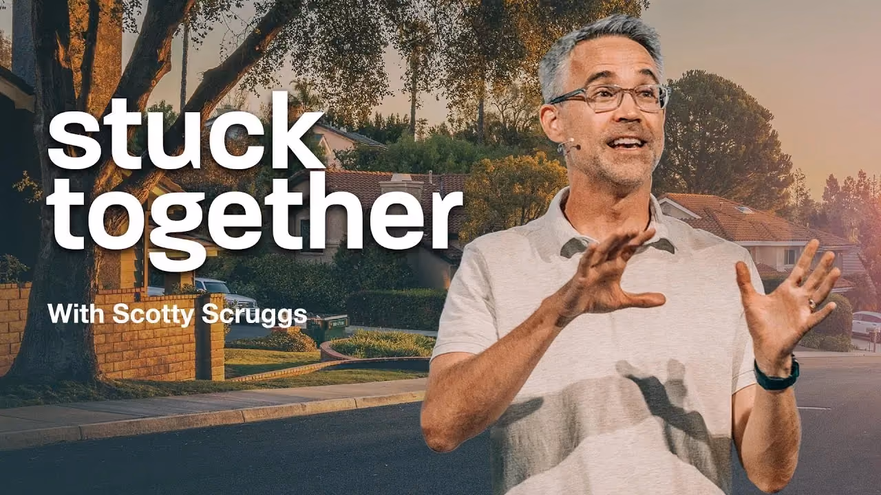 Stuck Together with Scotty Scruggs, gesturing on a suburban street at sunset.