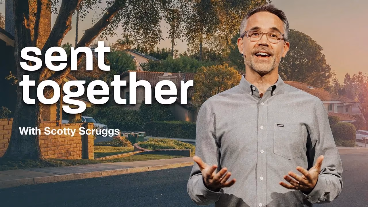 Sent Together with Scotty Scruggs, hands open on a suburban street at sunset.