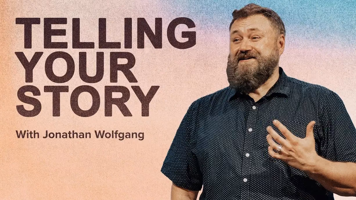 Telling Your Story with Jonathan Wolfgang, gesturing in a dark patterned shirt.