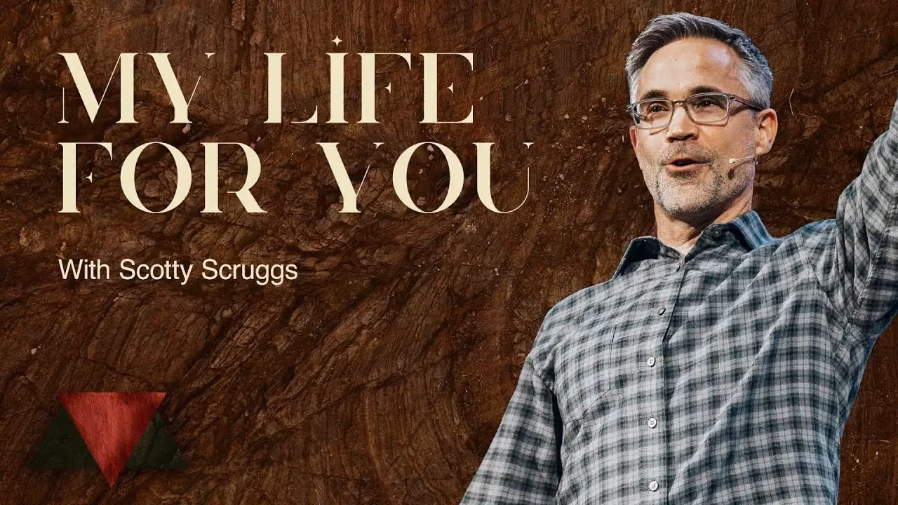 My Life For You with Scotty Scruggs, one arm raised in a grey plaid shirt on dark wood.