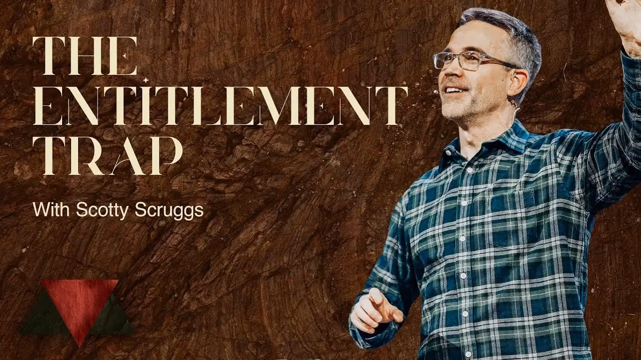 The Entitlement Trap with Scotty Scruggs, arms raised in a plaid shirt against dark wood.