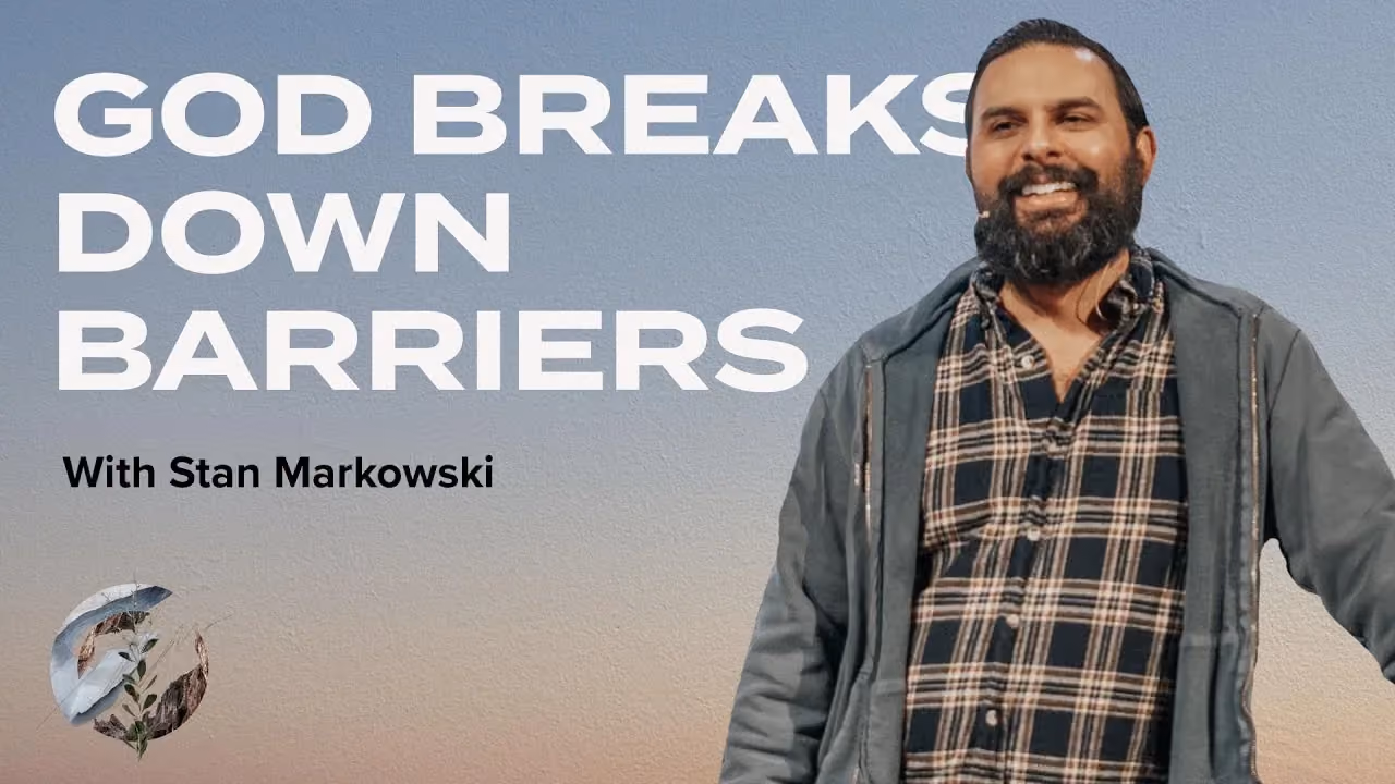 God Breaks Down Barriers with Stan Markowski, smiling in a plaid shirt and jacket at dusk.
