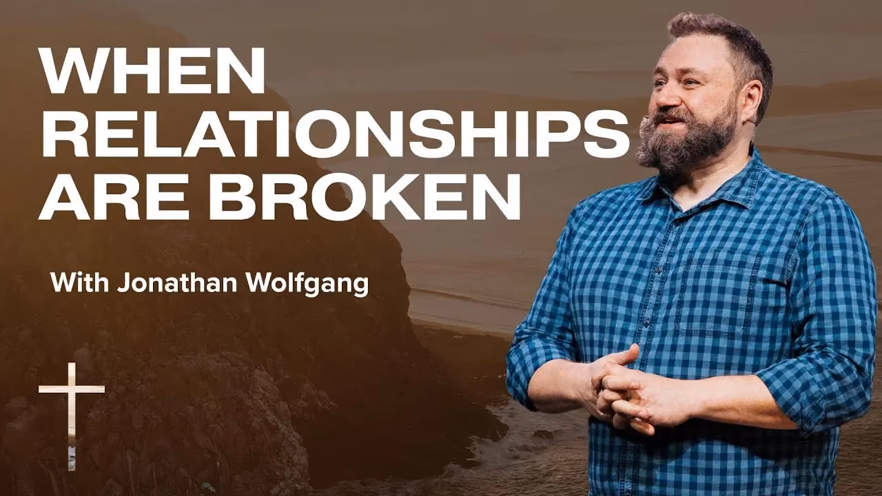 When Relationships Are Broken with Jonathan Wolfgang, hands clasped before a coastal cliff.