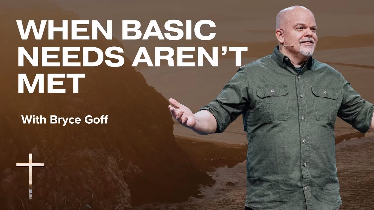 When Basic Needs Aren't Met with Bryce Goff, arms open in a green shirt before a cliff.