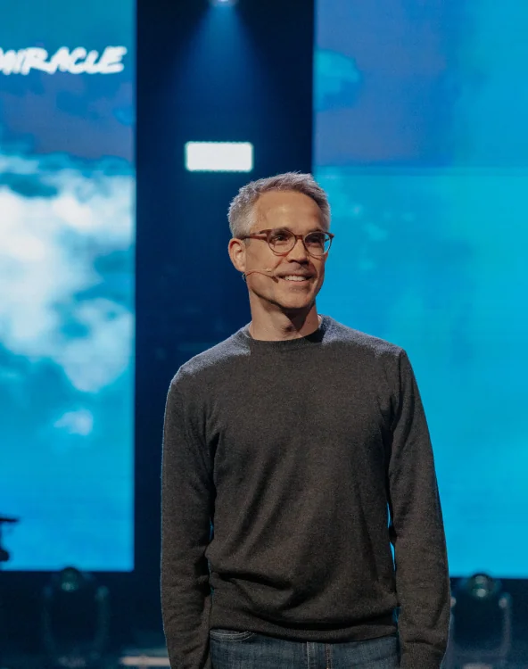 A man speaking on stage during a service at Northshore Church.