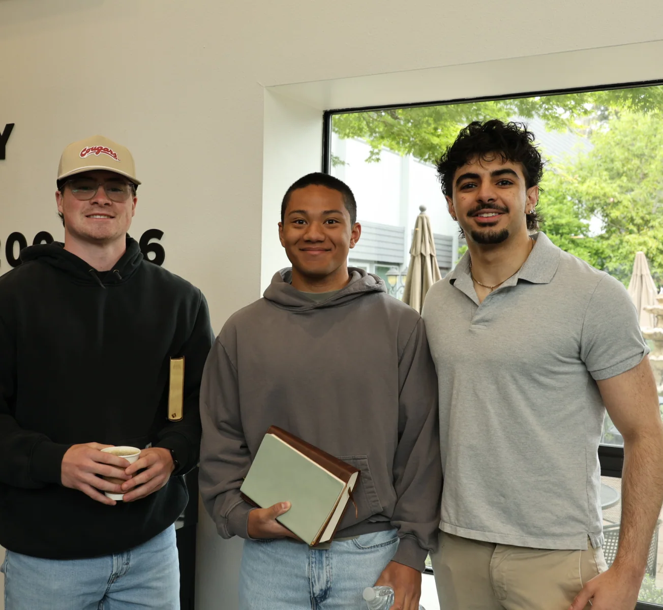 Three young men standing together at Northshore Church.