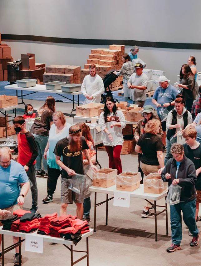 People packaging goods together at a Connect service event.