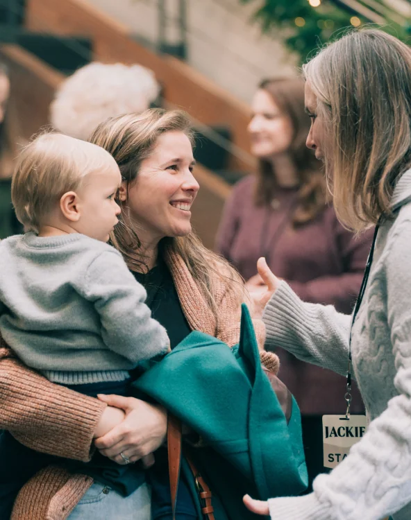 A mother holding her baby at a Northshore Church Serve event.