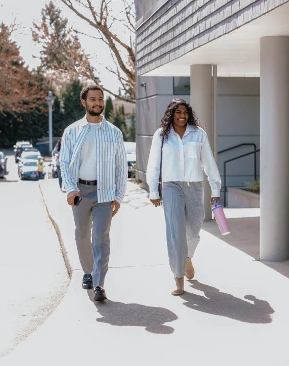 Two people walking outside the Northshore Church building.
