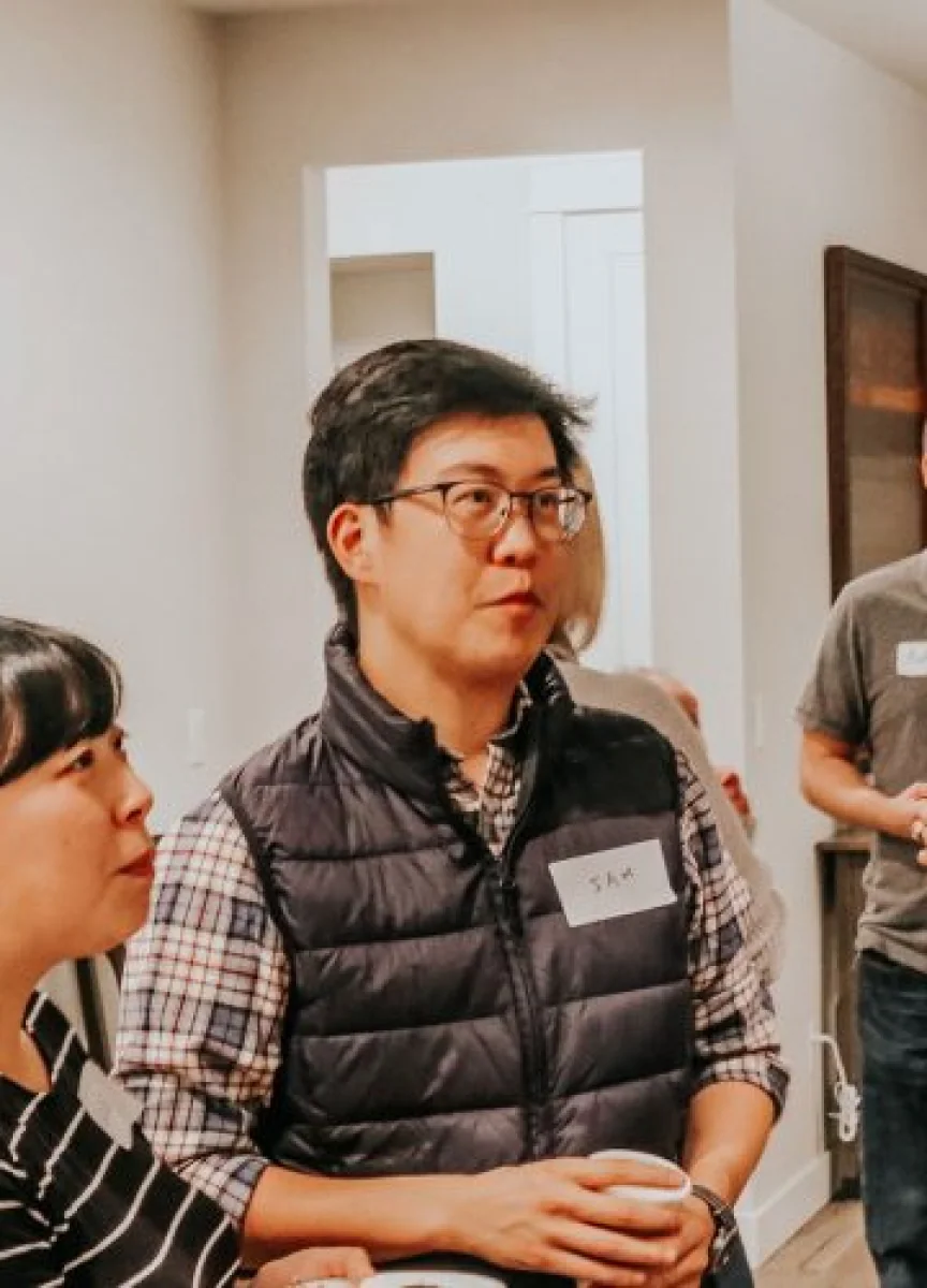 A man in glasses and a vest at a Northshore Church event.