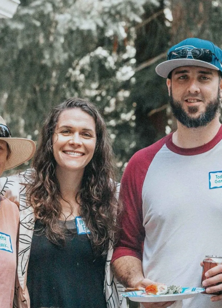 People smiling outdoors with food at a Northshore Church event.