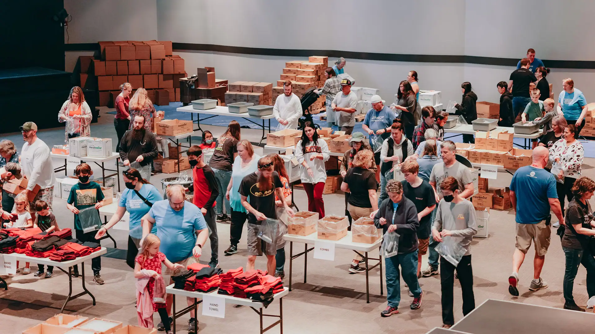 Volunteers packing boxes at an outreach event.