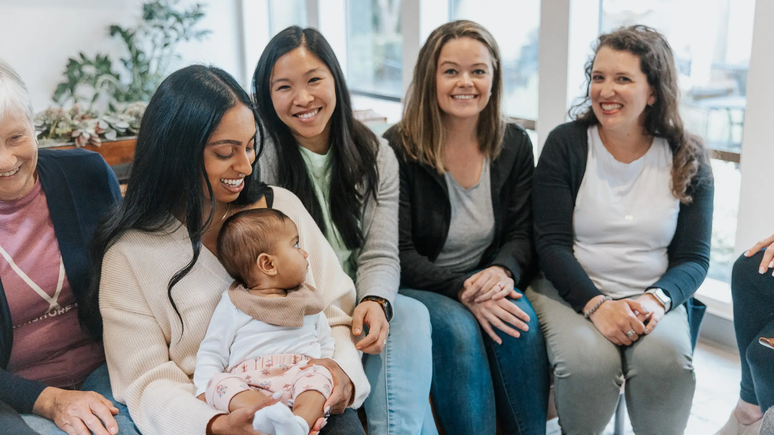Smiling mothers together with a baby at MomCo.