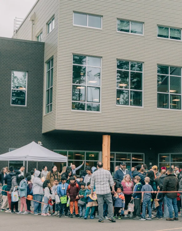 Students gathering outside a school building.